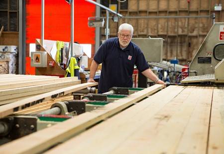 A JDT Team Member working on with wood