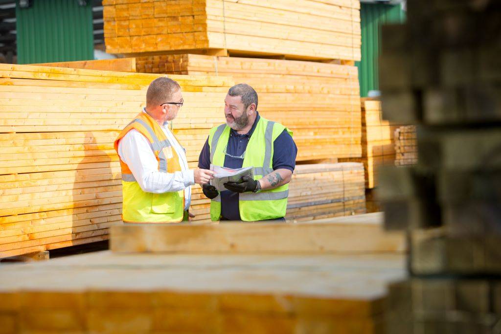 A JDT Team Members working on with wood